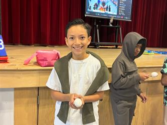 Turkey trot winner holding an egg